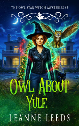 Book cover for 'Owl About Yule' by Leanne Leeds. An illustrated woman with dark hair stands on a snowy beach at night in front of a grand coastal mansion. She is accompanied by a small brown owl and a large, sleek black panther.